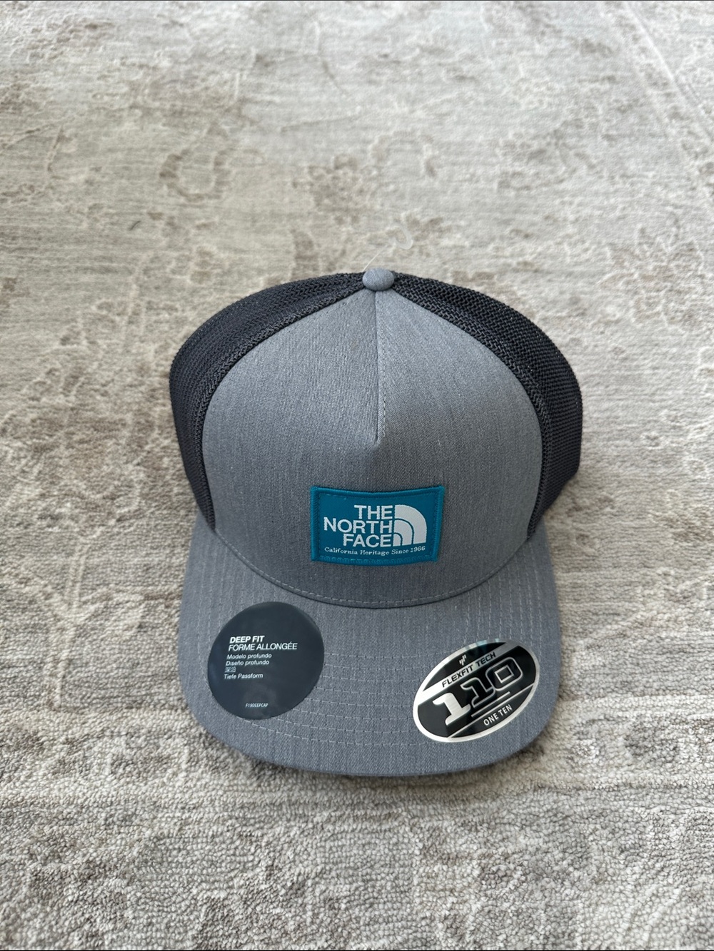 The North Face “Keep it patched” trucker hat. Grey with blue patch. NWT’s.